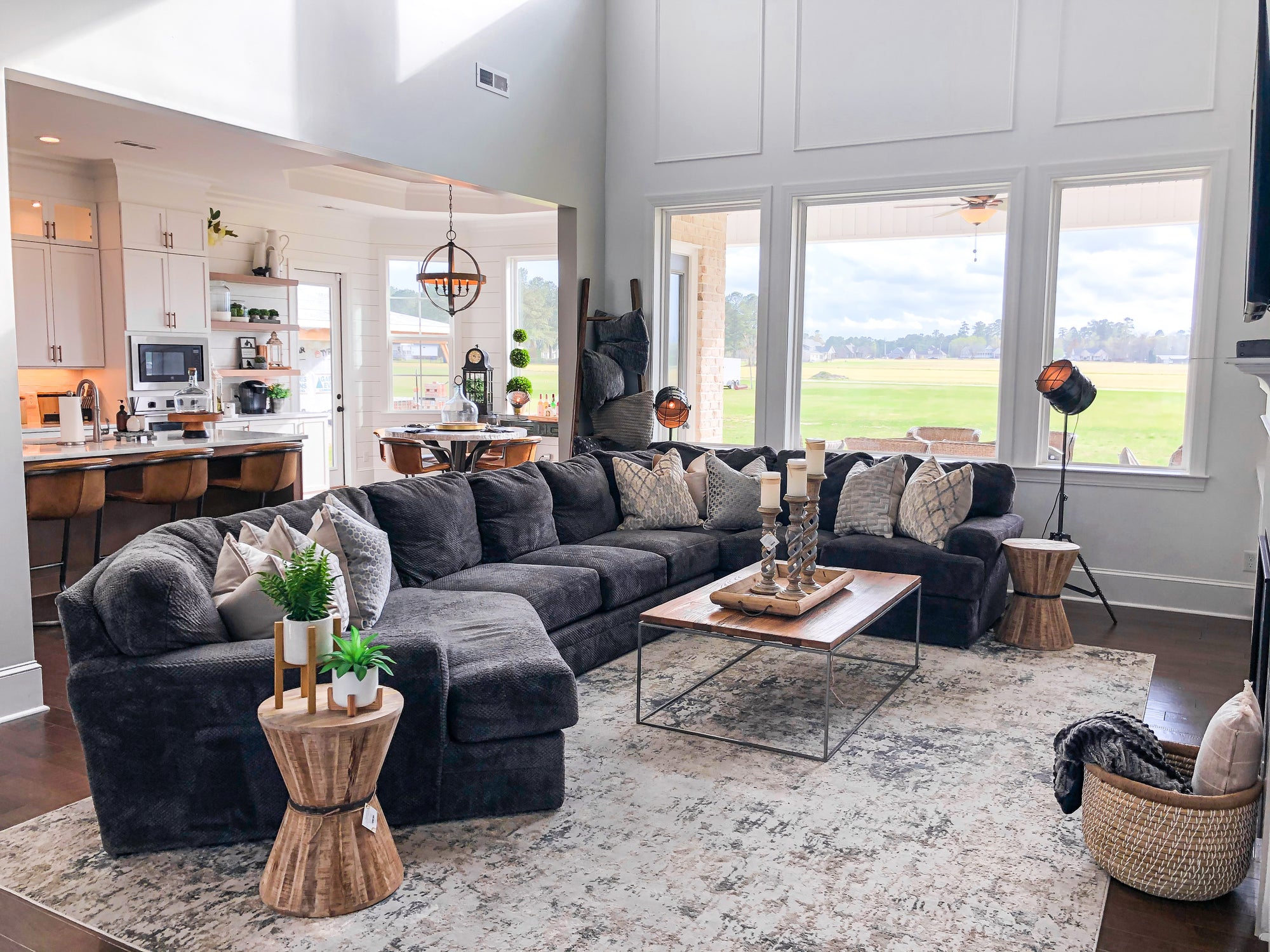 gray sectional with new pillows, new tables, baskets and lighting