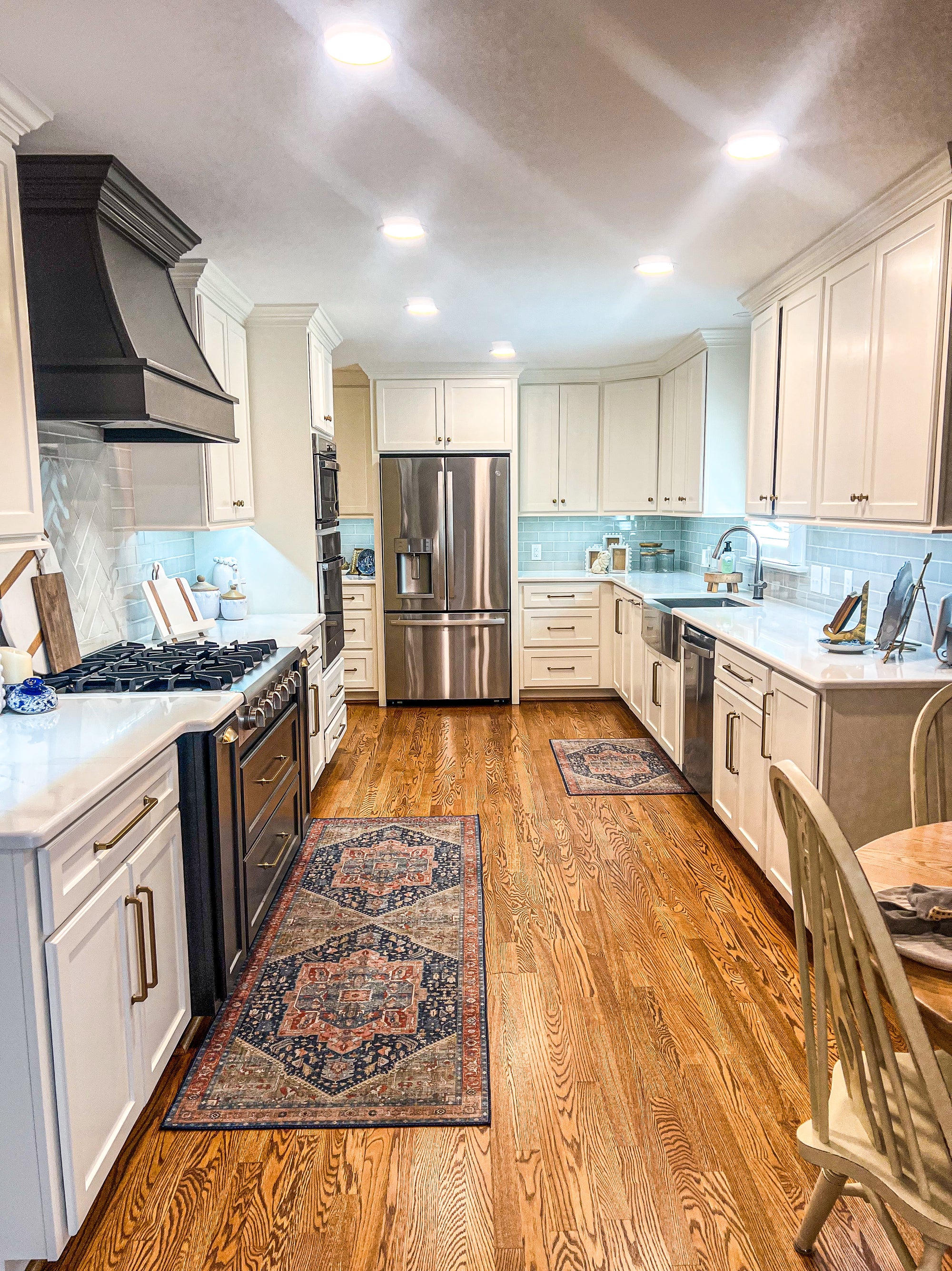 updated kitchen with new cabinets, stove hood, floors, and appliances